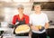 Woman and man chefs showing a meal they prepared in a food truck