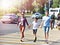 Woman, man and child cross road at crosswalk