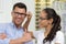 Woman and man choosing new glasses at optics store