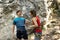 Woman and a man climbing a large rock