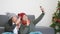 Woman and man funny making taking selfie together with smartphone