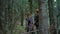 Woman and man hiking in forest. Smiling tourists having adventure in woods