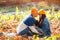 Woman and man kissing in autumn park. Love, relashionship and lifestyle. Autumn mood, vacation