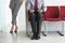 Woman By Man With Laptop On Chair In Corridor