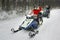 Woman and Man managing snowmobile in Ruka of Lapland