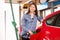 Woman man refuelling a car at a petrol station