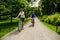 Woman and man riding bicycles at summer green park