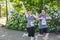 Woman and man runners give happy signs during 5K run