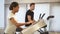 Woman and man running on treadmill machine