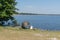 Woman and man seated next to the lake fishing and relaxing in Lacanau France