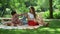Woman and man sitting on blanket in park. Couple looking at each other at date