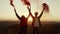 Woman and man with smoke bombs standing in meadow. Guy and girl having fun