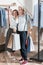 Woman and man standing with shopping bags between racks with clothes