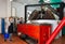 Woman and man supervising milling olives in crusher machine