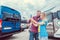 Woman and man taking selfie in front of RV or camper in anticipation