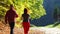 Woman and man walking cross country trail in autumn forest