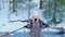 A woman and a man walking on a suspension bridge in a snowy nature Park