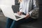 Woman manager sits on the sofa typing at her laptop , cozy office atmosphere concept