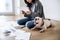 Woman managing the debt sitting with pet dog