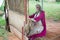 Woman mannequin weaving a handmade carpet