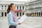 Woman with map on piazza san marco in venice