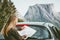 Woman with map planning route traveling by rental car