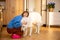 Woman with Maremma dog at home