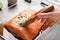 Woman marinating raw salmon in dish