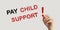 Woman with marker and phrase PAY CHILD SUPPORT! on beige background, closeup. Banner design