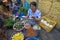 Woman in market with handhold scale