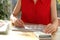 Woman marking date in calendar at wooden table