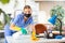 Woman in mask wiping dust from desk