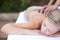 Woman, massage and hot stones to relax, back and spa for treatment and stress relief therapy. Sleeping, masseuse and