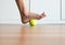 Woman massage with tennis ball to her foot in bedroom,Feet soles massage for plantar fasciitis,Close up