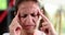 A woman massages temples fingers, shallow focus