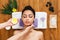 Woman massagist make face lifting massage in spa wellness center