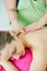 Woman masseur doing girl massage in Spa salon close-up