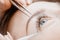 Woman master making fake long lash Eyelash extension procedure