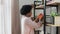 woman with matchsticks lighting candles at home