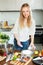 Woman mealing raw saltwater fish at kitchen table