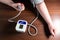 Woman is measuring blood pressure at home. Electronic sphygmomanometer. Medical treatment photo