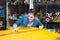 woman measuring material in haberdashery shop