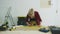 Woman measuring plywood sheet with spirit level