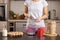 Woman measuring and sieving flour