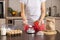 Woman measuring sugar on kitchen measuring scale