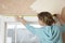 Woman Measuring Window Frame With Tape