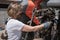 Woman mechanic repairing a tractor outdoors