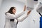 Woman in a medical coat adjusts a dental tomograph. Medical worker in the X-ray room.