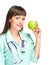 Woman medical doctor hold green fresh apple