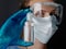 Woman in medical and eyes mask shows hand sanitizer gel dispenser close up nurse